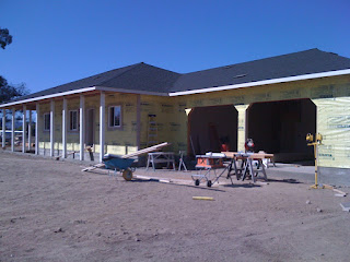 The house wrap is applied over the assembled wall panels