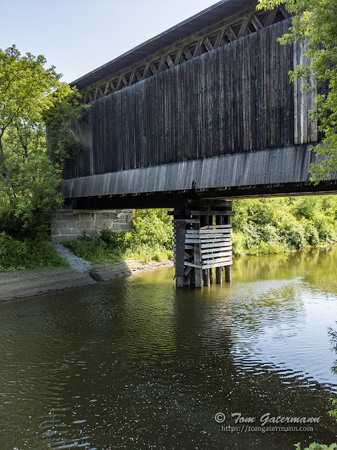 The northeast side of the Fisher Covered Railroad Bridge and the Lamoille River