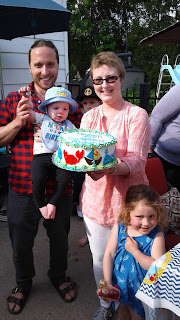 In this picture my husband holds Aiden on his first birthday. I stand holding a nautical themed cake and Ellie (3,5yrs) stands next to me.