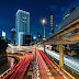 Cars zoom by on a July evening in the heart of Tokyo
