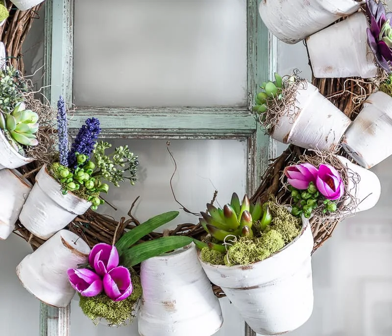 white aged flowerpot wreath, succulents, moss, purple Spring flowers
