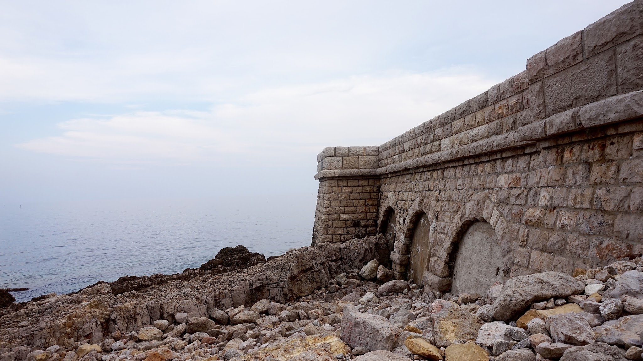 a large stone jetty looking out to sea