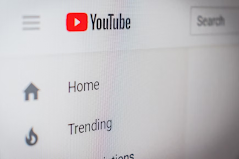 An image of the YouTube Homepage. It is showing a red button with a white triangle icon.