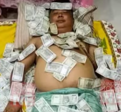  An Assam politician's photo resting on a mound of cash sparks controversy; a BJP associate explains