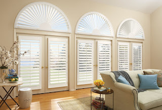 These Hunter Douglas NewStyle Shutters with Arch have a front tilt bar. Professional installation makes both the look and function work with the room.