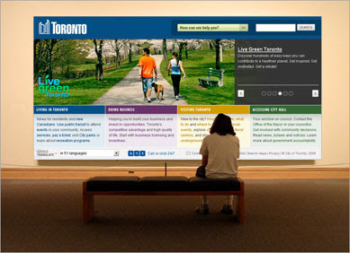 person sitting in front of large painting of toronto.ca front page