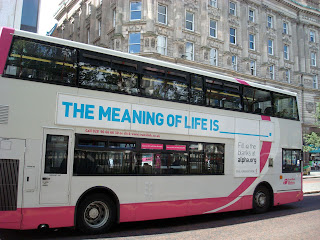 Alpha poster on the side of a Metro bus asking - The Meaning of Life is _______