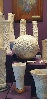 Colour photo showing exhibits in Knockaloe Visitor Centre made of carved animal bone including vases and other ornaments