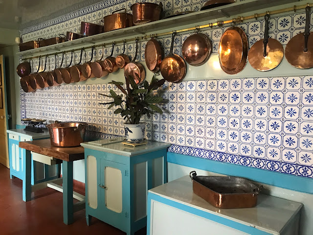 foto da cozinha de Monet com muitas panelas de cobre penduradas