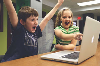 Children playing on a laptop