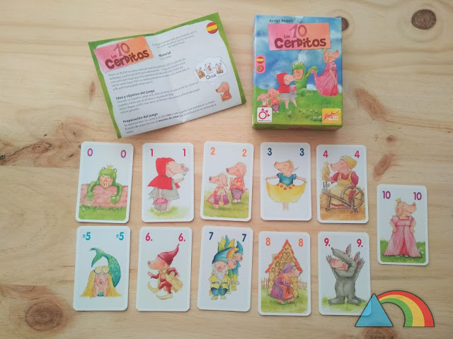 Contenido del juego Los 10 cerditos: Caja, instrucciones para jugar y 11 cartas ilustradas con dibujos de cerditos y numeradas del 0 al 10