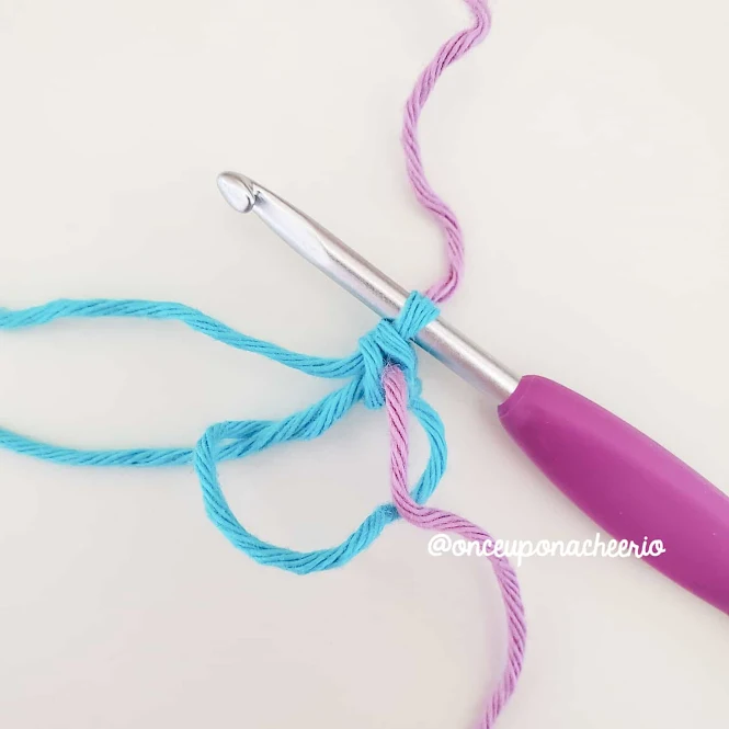 Crochet over your stitch marker so that the running stitch marker is now embedded in your stitch.