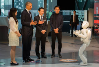 Barack Obama watches Asimo, a robot made by Honda (State Department photo by William Ng / public domain).