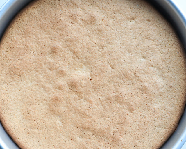 circular lemon cake from above still in metal pan