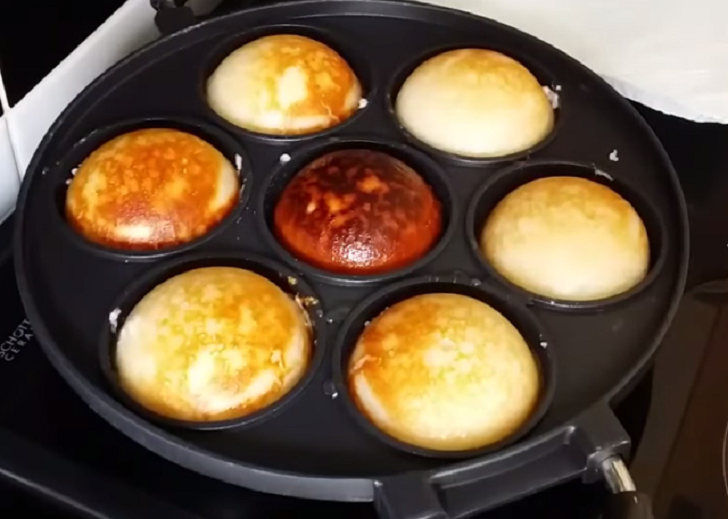 Frying coconut and rice donut (Vitumbua) in a pan