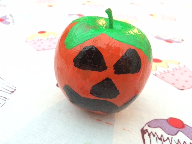 Apple painted as a pumpkin