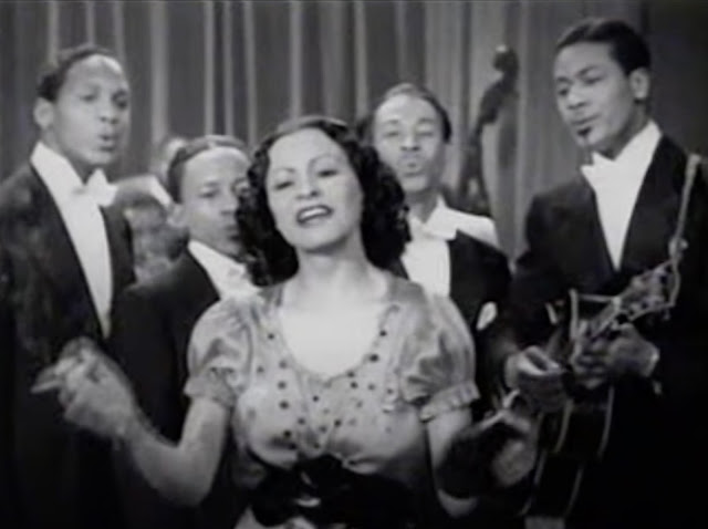 screenshot of Josephine Pearson Edwards performing with The Four Toppers (Steve Gibson & the 5 Red Caps) in the 1940 movie, Mystery in Swing