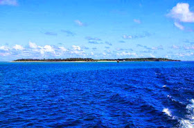 island in blue seas under blue skies
