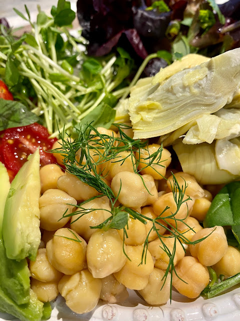 platter of salad with chickpeas, avocado, sprouts