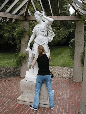 Funny posing near statues Seen On www.coolpicturegallery.net
