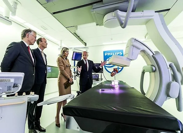 Employees of Philips' Innovation and Production Centre in Best take pictures of Netherlands' Queen Maxima during a visit