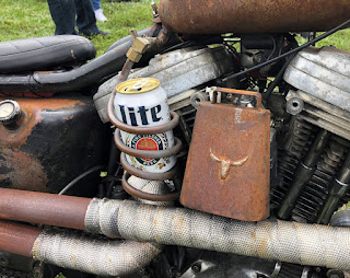 Crude cup holder attached to motorcycle.