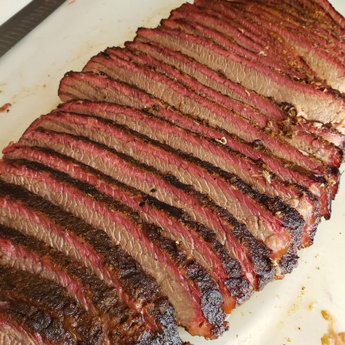 Sliced smoked brisket flat with a beautiful smoke ring