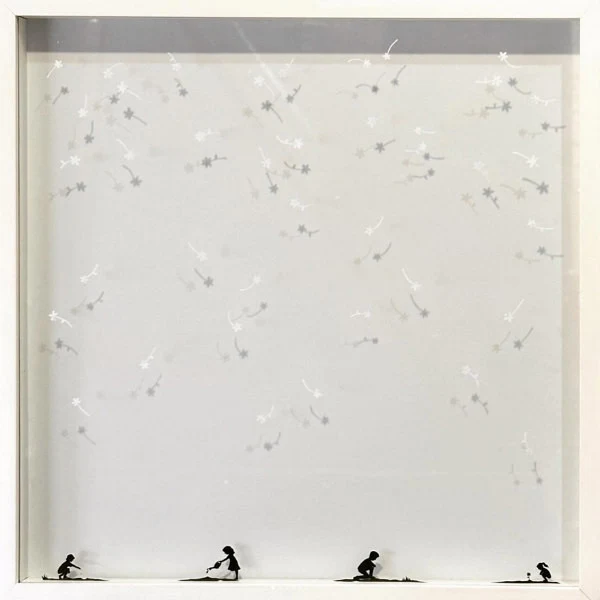 square white box frame with four miniature paper cuttings of children positioned across bottom with tiny flowers scattered across remainder of space