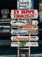 Signs in various languages indicating different locations.