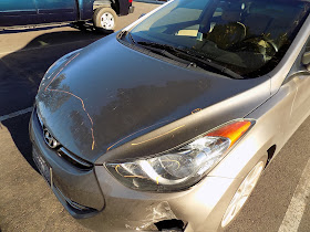 Hyundai Elantra with scraped hood, bumper and headlights before repairs at Almost Everything Auto Body.