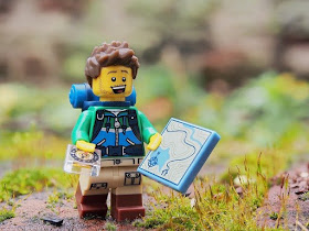lego hiker with map and compass