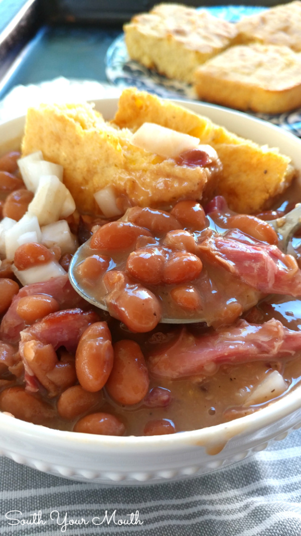 Slow Cooker Pinto Beans! Creamy, tender pinto beans cooked in the crock pot with smoky ham hocks or leftover ham with a silky sauce perfect with cornbread or over rice (stove-top instructions included).