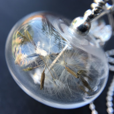 Lampwork glass bead and sterling silver necklace filled with dandelion clock seeds