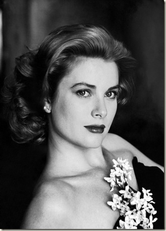 Portrait of actress Grace Kelly wearing strapless gown with artificial flowers.  (Photo by Sharland)