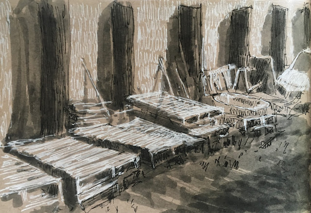 Pen, inkwash and white ink sketch of pallets piled up in sunlight and shadow.