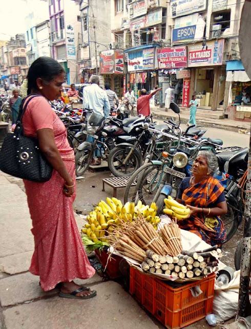 fruit vendor selling sugarcane sticks