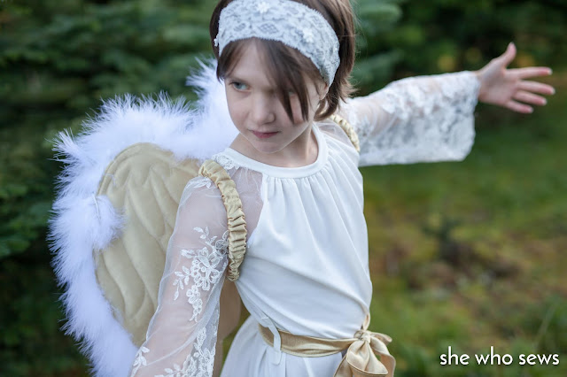 Girl in white lace dress with wings