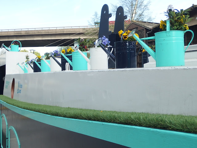 Flower-filled watering cans