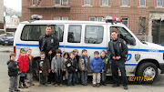 In addition to visual warnings, most police cars are also fitted with sirens . (february literacy month police officers )