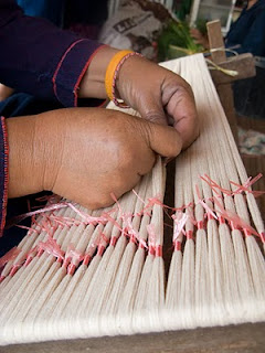 tie-dyeing yarns to create a mudmee design when yarns are woven