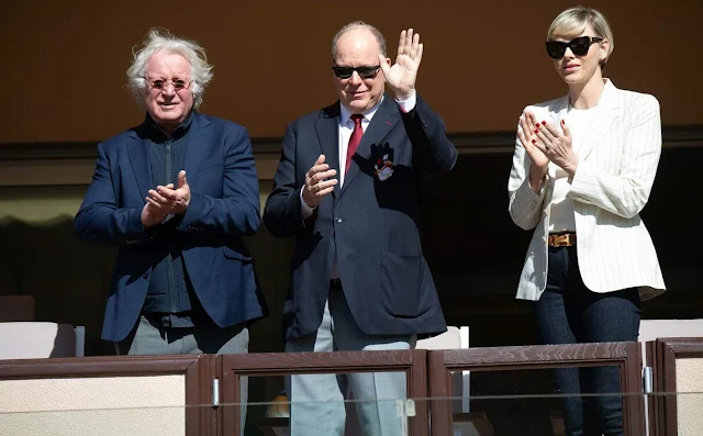 Princess Charlene wore a new Skye pinstripe cotton-linen jacket by Ralph Lauren Collection, and navy denim jeans