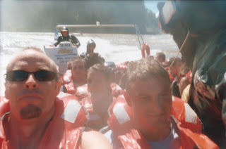 A girl sticking out her tongue between Chad and I as we get soaked under the falls.