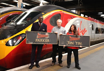 Thunderbird characters Parker and Tin diesel locomotive nameplates, which raised thousands of pounds for charity at auction, being held up for the camera by railway staff