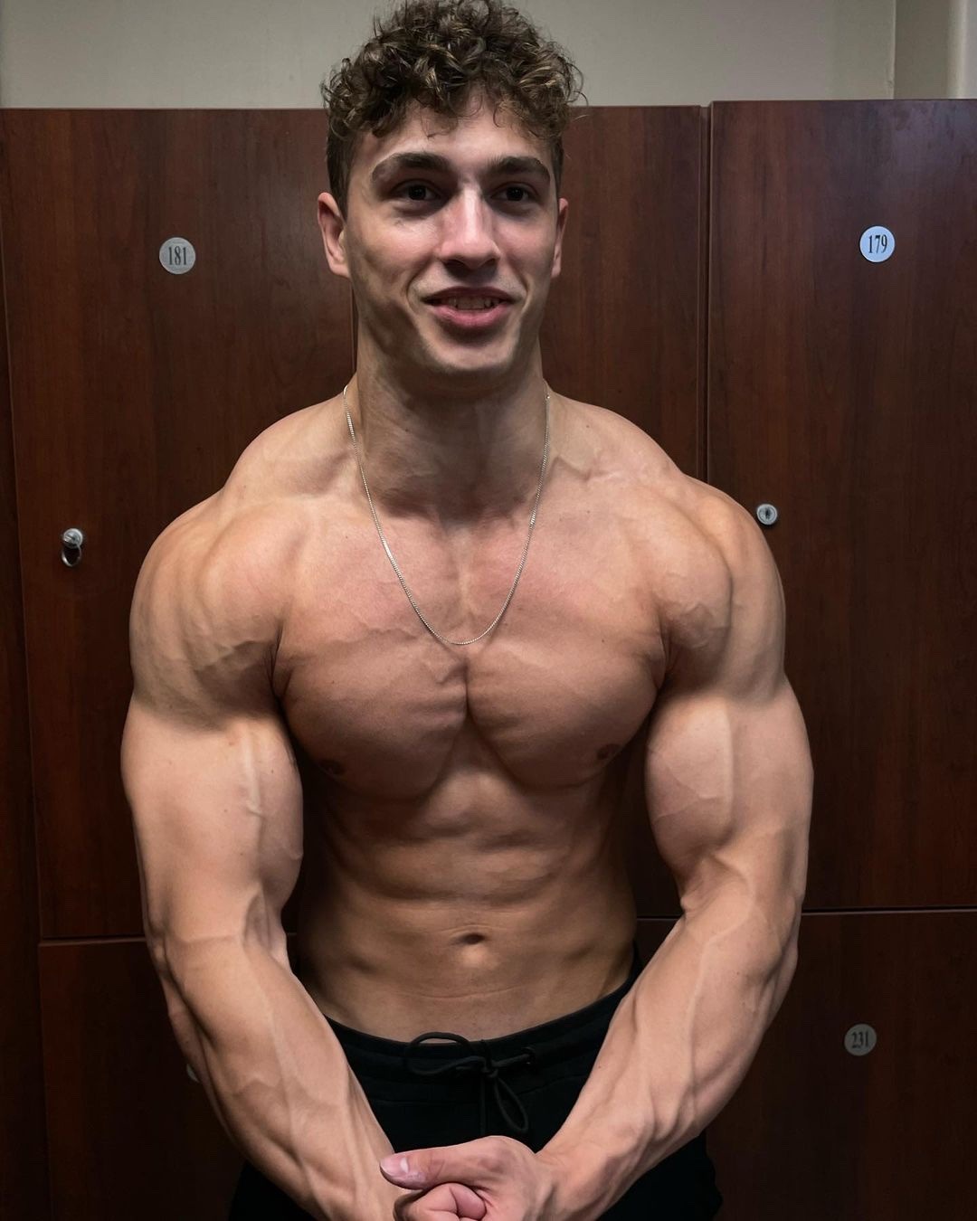 young-hot-muscle-guy-fooling-around-locker-room-arms-flex-naughty-bro-smile