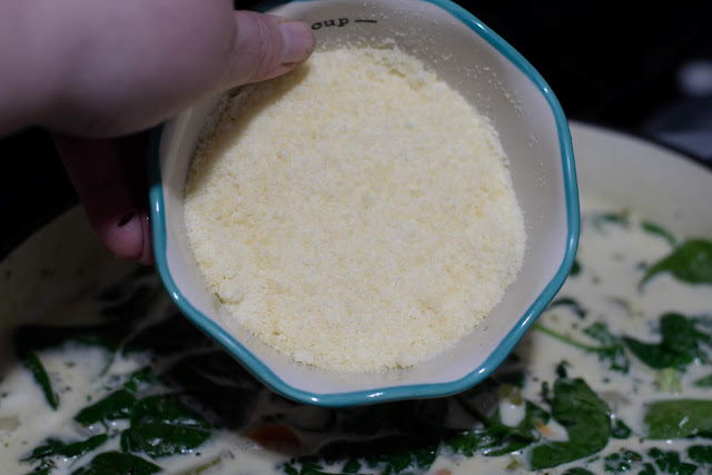 Grated parmesan cheese being added to the soup.