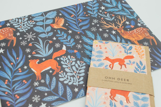 Navy blue wrapping paper with a fox and floral print all over