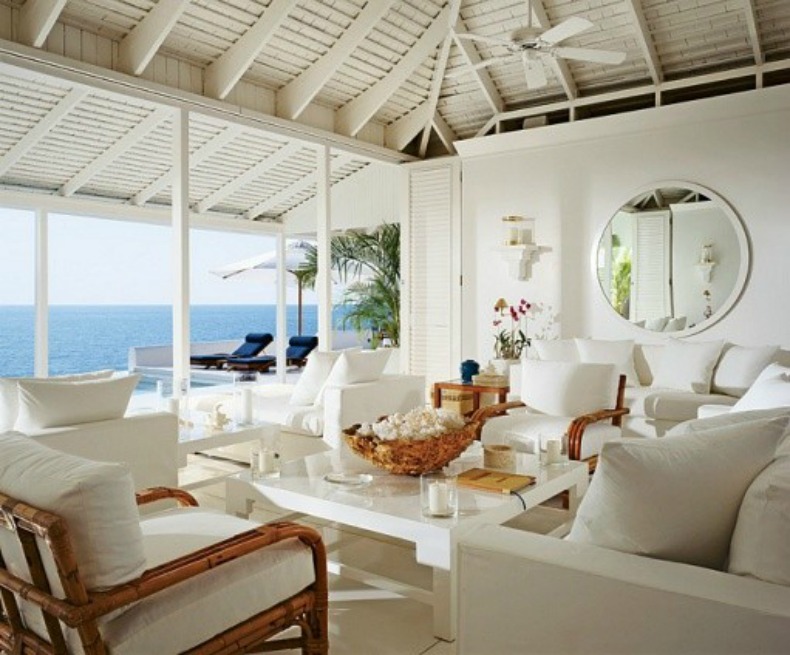 White slipcover sofas, chairs and rattan lounge chairs create a clean 