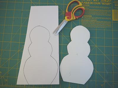 2) Begin decorating the snowman body. Cut out a paper scarf and hat and 