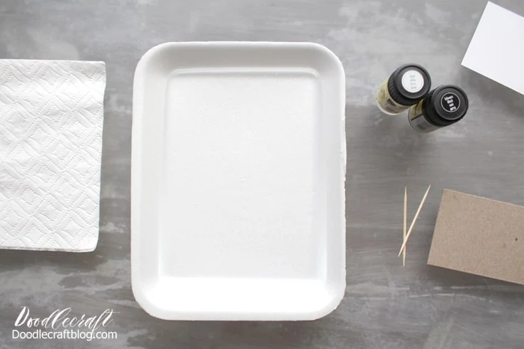 Supplies needed for Easy Marble marbling.  Styrofoam shallow dish with 1/4 inch of water.  Easy Marble in black and white.  White card stationery.  Toothpick, gloves, paper towels, acetone.