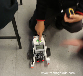 Child pressing button on EV3 robot